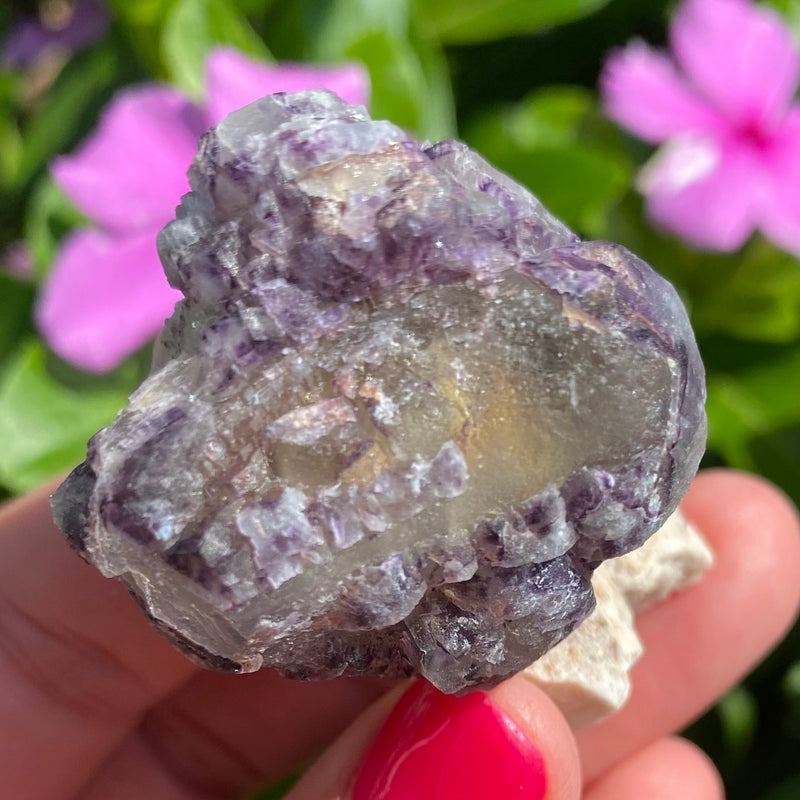 Little purple fluorite cluster on feldspar